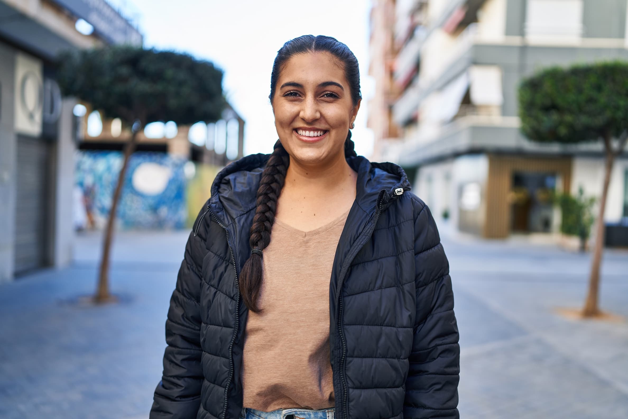 hispanic woman smiling confident standing in the street